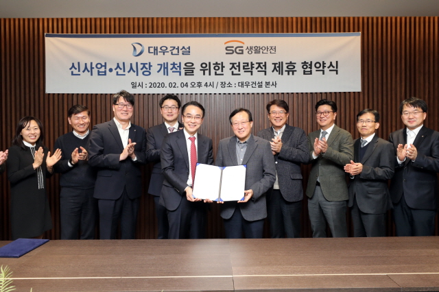 SG생활안전 이상룡 대표(왼쪽 다섯번째)와 대우건설 신사업본부장 김창환 전무(왼쪽 여섯번째)가 을지로 대우건설 본사에서 전략적 사업제휴를 위한 양해각서를 체결하고 기념사진을 촬영하고 있다./대우건설 제공